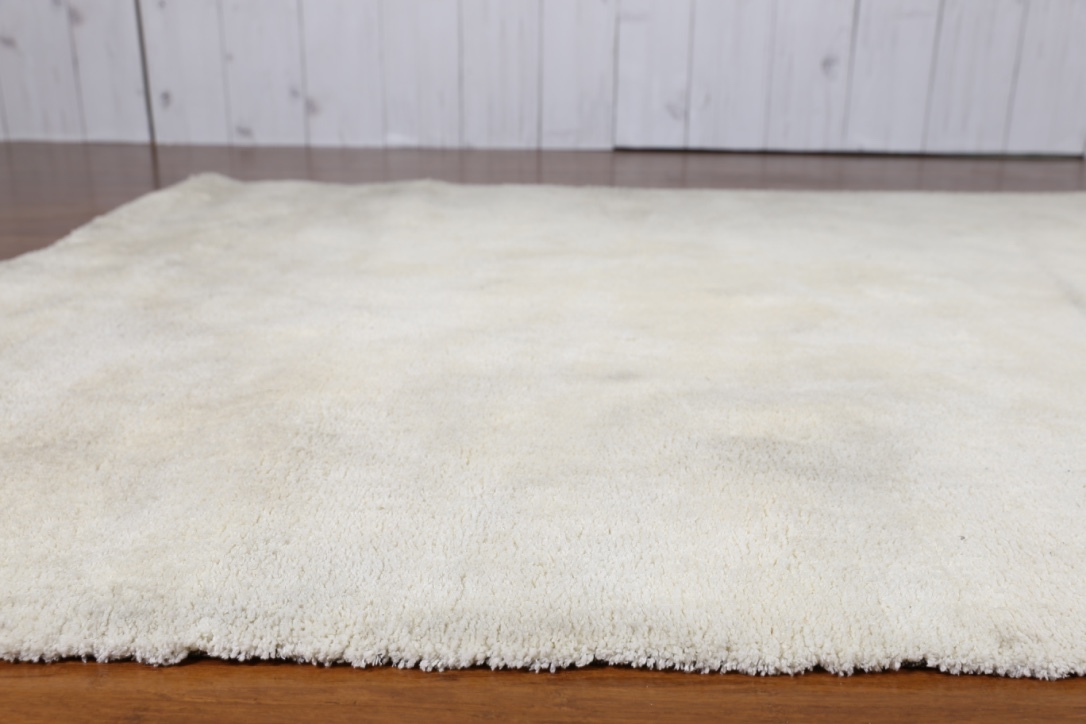 cream fluffy living room rug