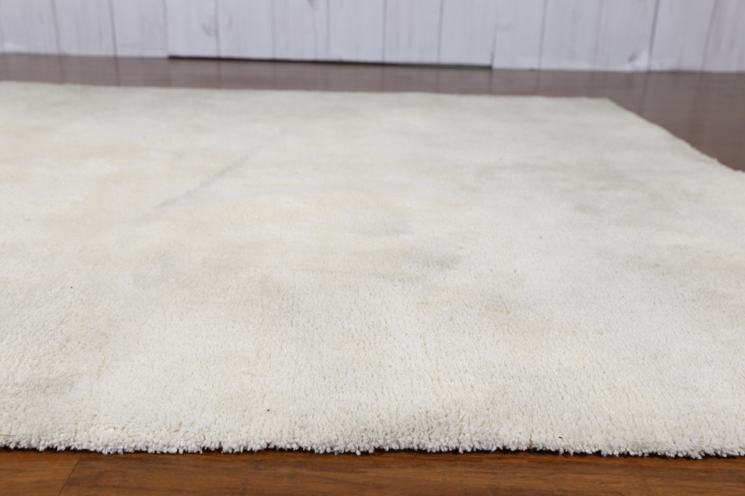 cream fluffy living room rug